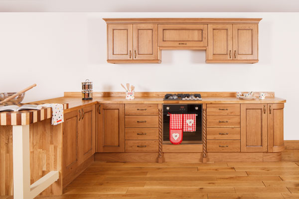 Traditional lacquered oak cabinets and solid oak worktops with corner cabinets and pilasters